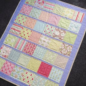 DIY Appliquéd Strip Quilt. This quilt is made using a faux quilting technique