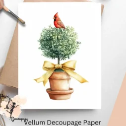 Image of a topiary with a golden bow and a cardinal perching on it.